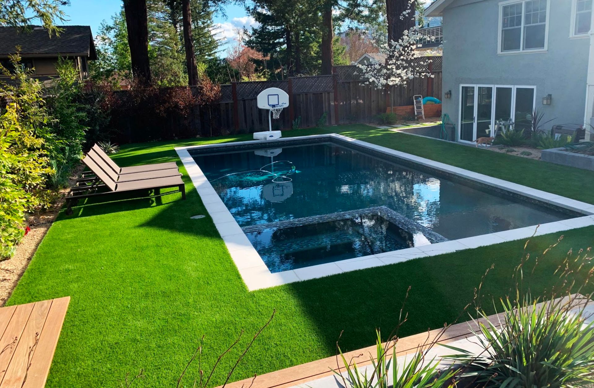 artificial grass installed around a pool